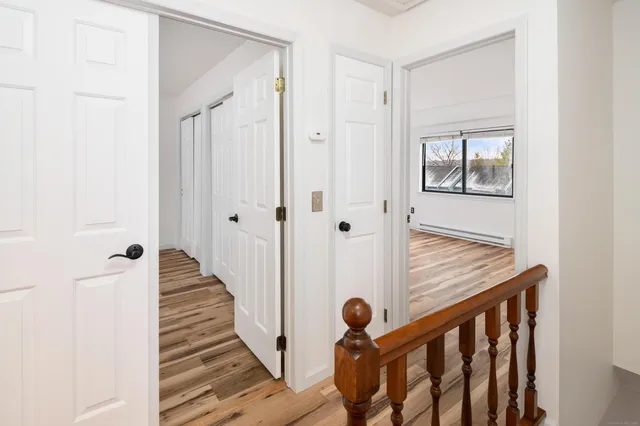 a view of empty room with wooden floor
