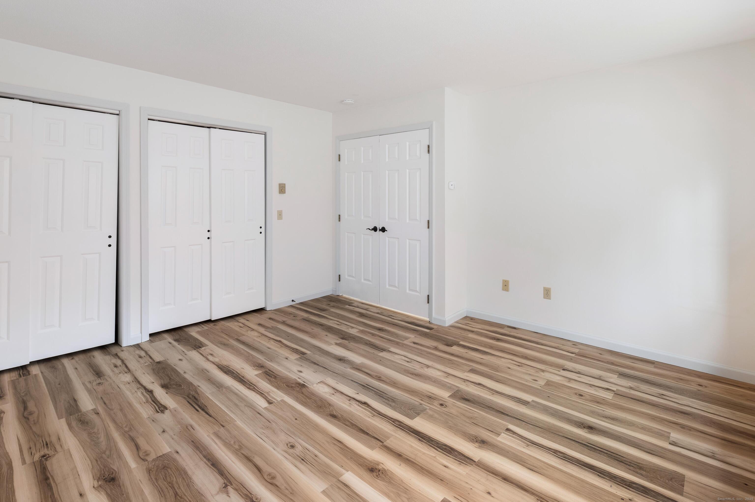 8 Driftway Road, Unit C1 Danbury, CT 06811 - Photo 10 of 23 a view of a room with wooden floor and white doors