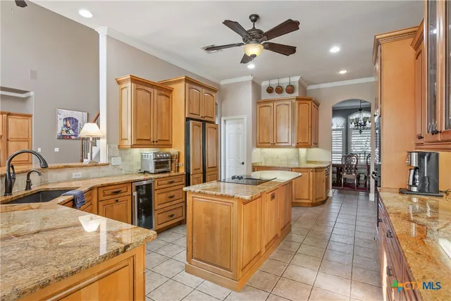 a large kitchen with stainless steel appliances granite countertop a sink dishwasher stove and oven