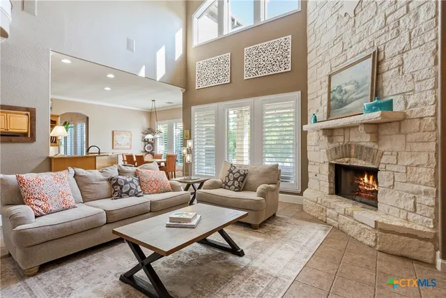 a living room with furniture and a fireplace