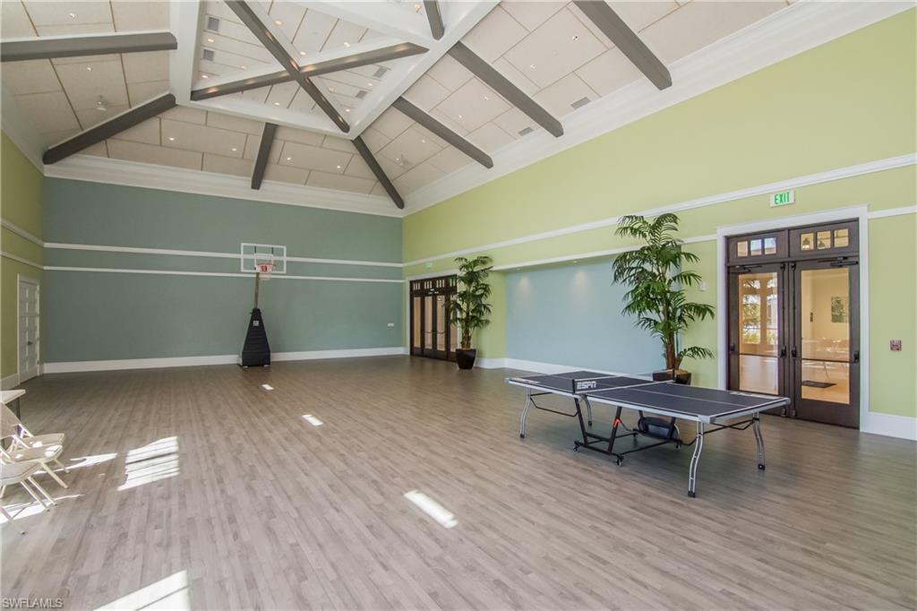 6552 Dominica Drive, Unit 101 Naples, FL 34113 - Photo 37 of 50 a view of a room with wooden floor and stairs