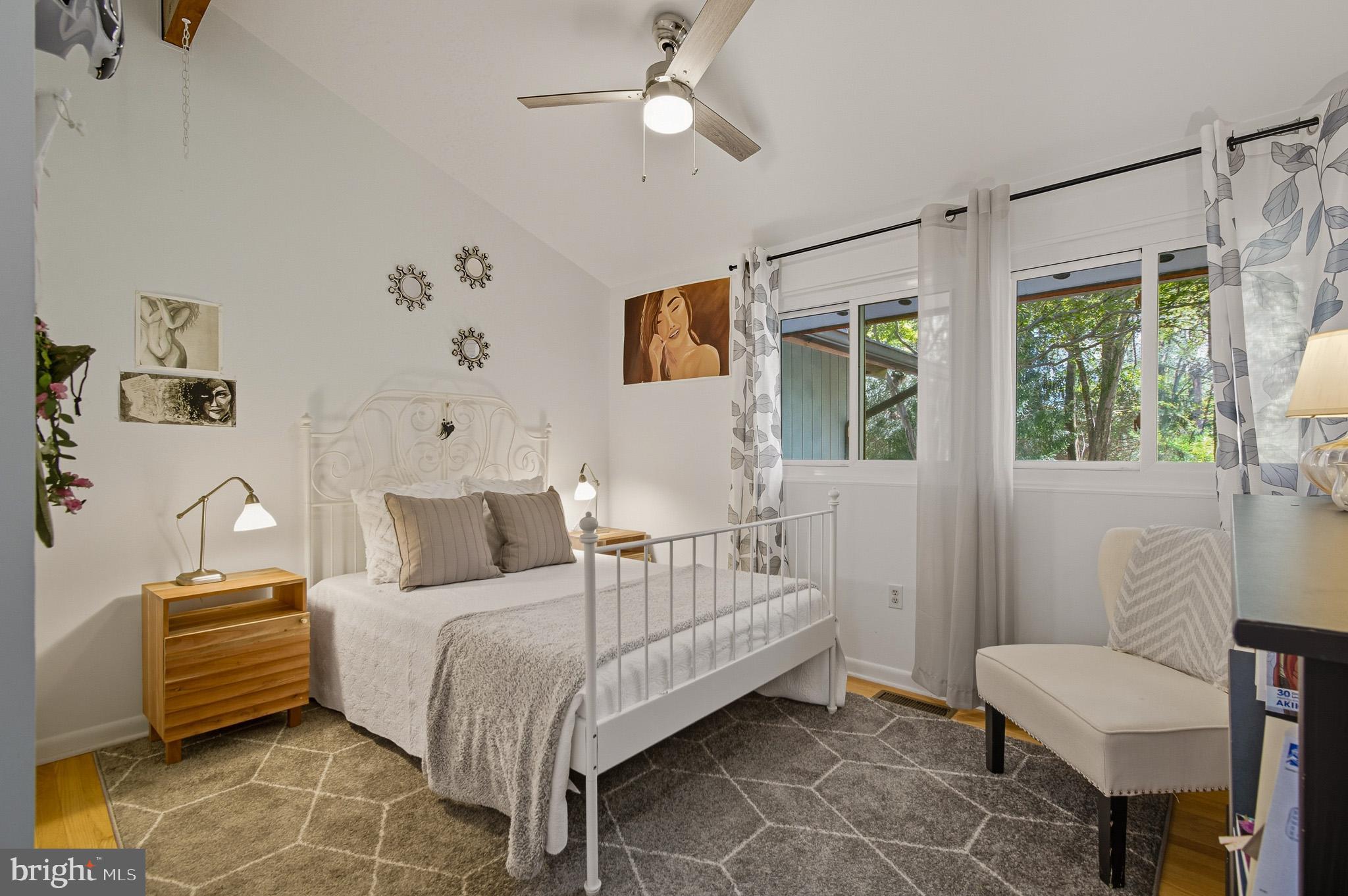 7145 Deer Valley Road Highland, MD 20777 - Photo 24 of 75 a bedroom with a bed a couch and a window