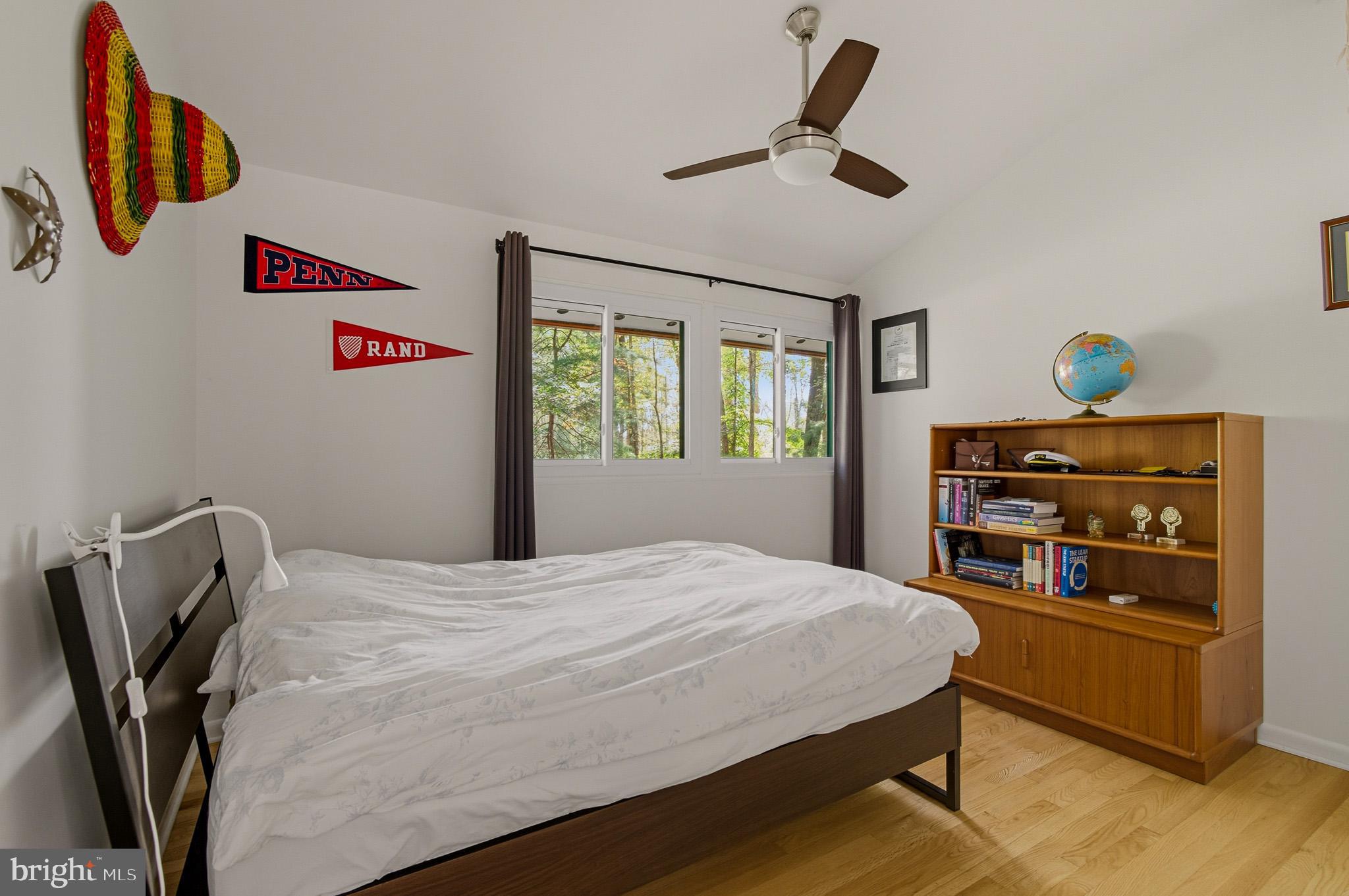 7145 Deer Valley Road Highland, MD 20777 - Photo 28 of 75 a bedroom with a bed a dresser and book self