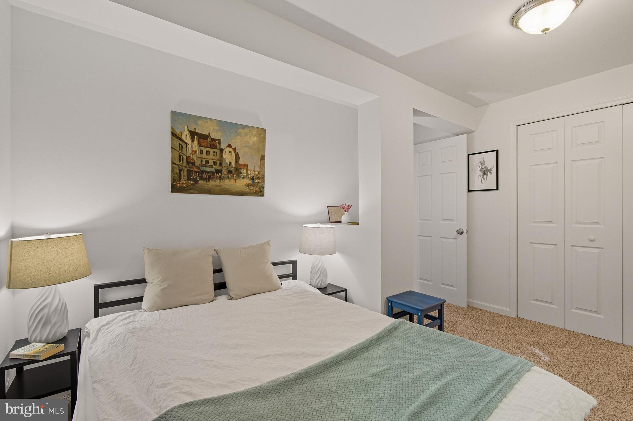 7145 Deer Valley Road Highland, MD 20777 - Photo 41 of 75 a bedroom with a bed and a painting on the wall