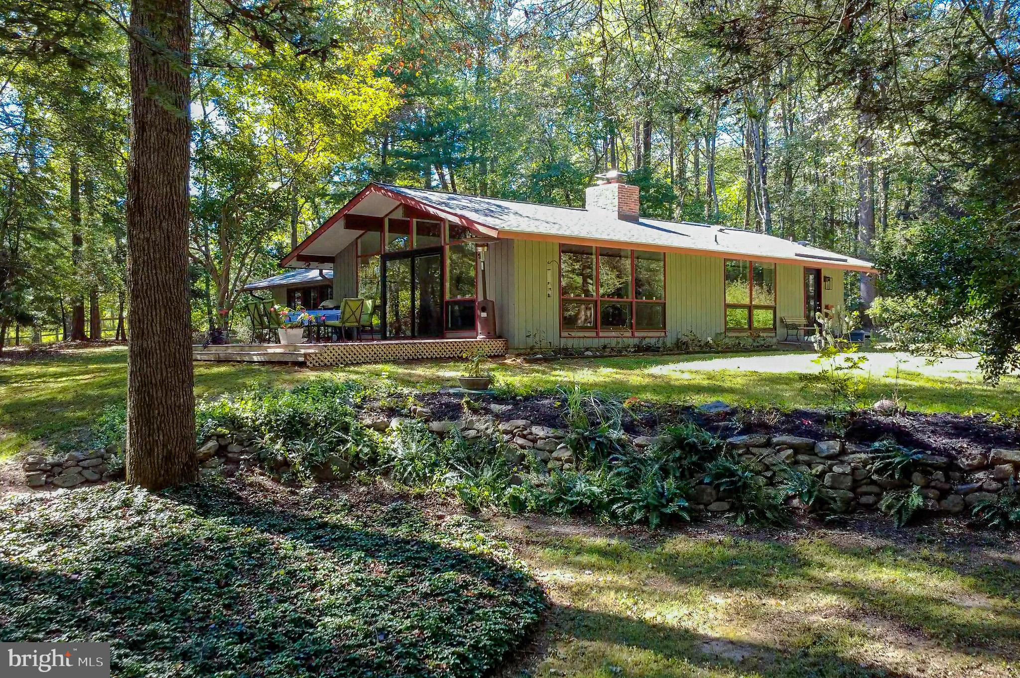 7145 Deer Valley Road Highland, MD 20777 - Photo 56 of 75 a front view of a house with a yard table and chairs