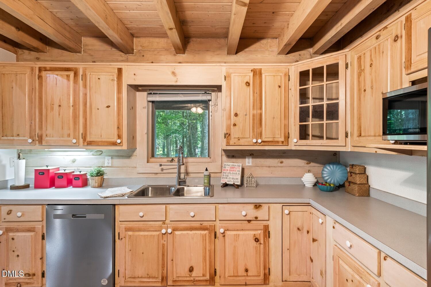 7391 Howerton Road Elon, NC 27244 - Photo 23 of 53 Exposed wood beam ceiling, natural wood cabinetry, stainless steel dishwasher, built-in microwave, and a single basin stainless steel sink