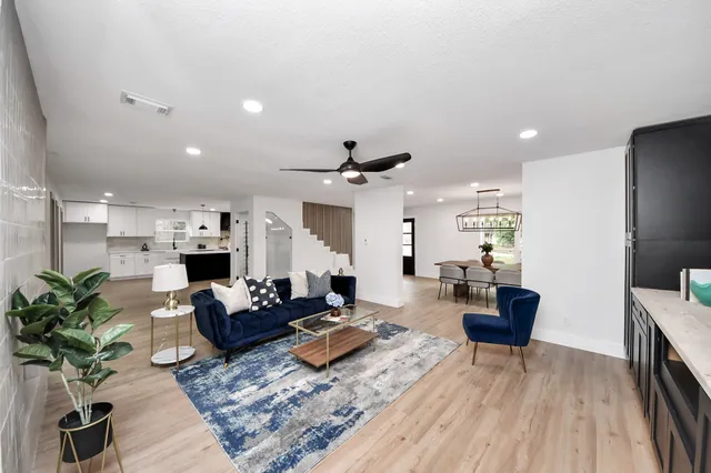 a living room with fireplace furniture and a wooden floor