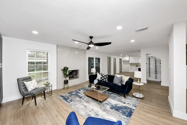 a living room with furniture and wooden floor
