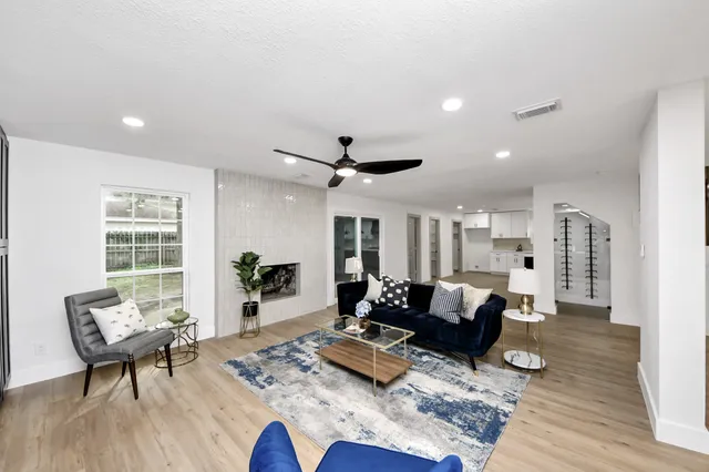 a living room with furniture and wooden floor