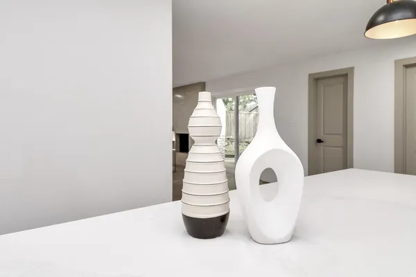 a view of living room kitchen with a sink and chandelier