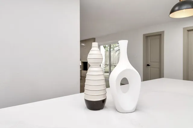 a view of living room kitchen with a sink and chandelier