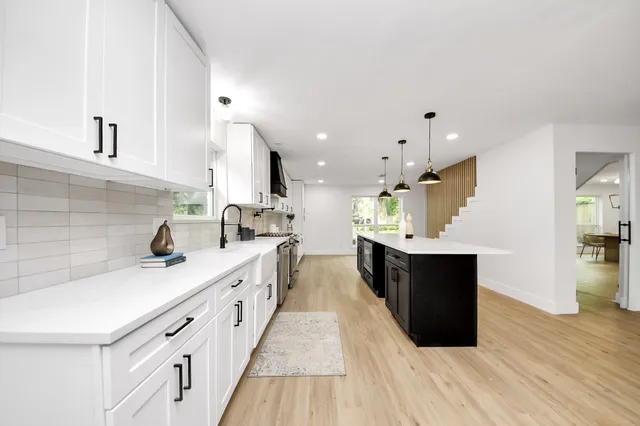 a kitchen with cabinets appliances and a window
