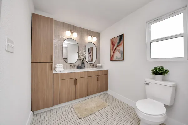 a bathroom with a toilet sink and shower