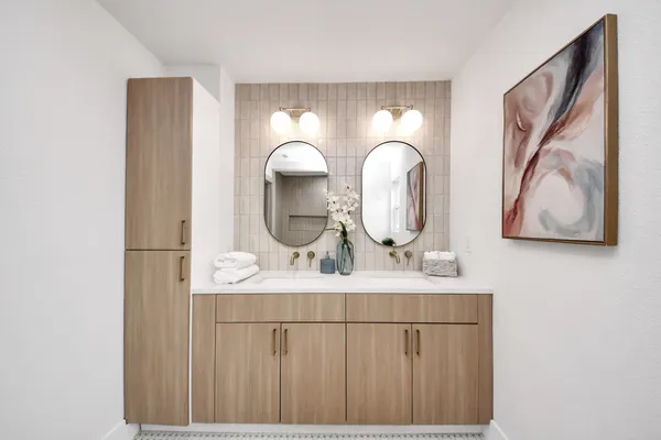 a bathroom with a sink mirror and vanity