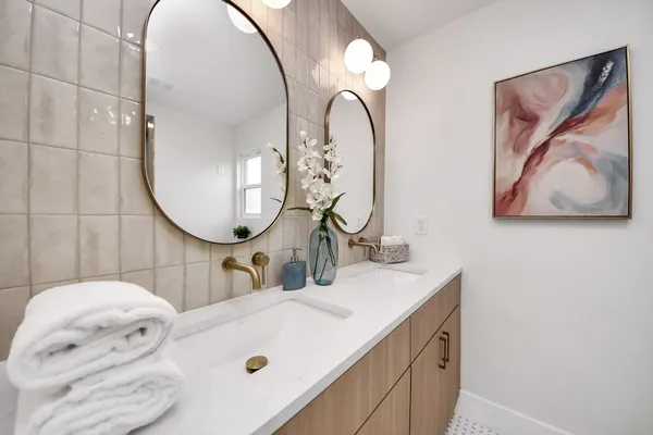 a bathroom with a mirror and vanity