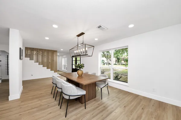 a view of a dining room with furniture window and wooden floor