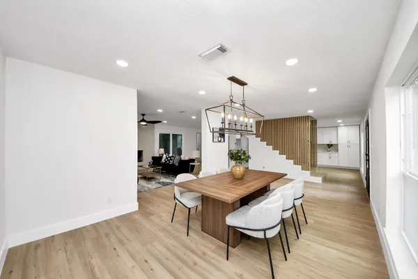 a view of a dining room with furniture and wooden floor