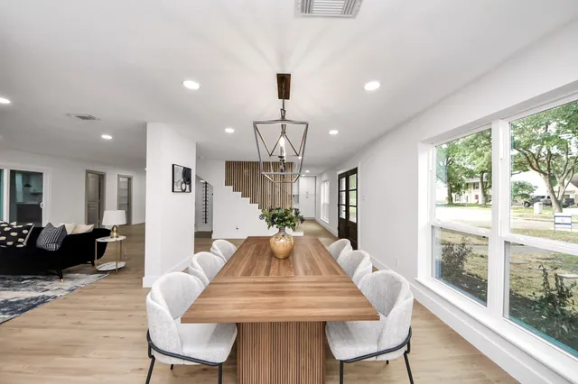 a view of a dining room with furniture window and wooden floor