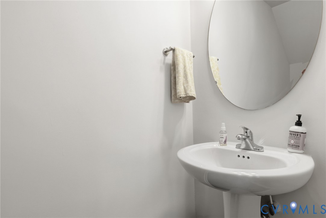 1925 Kennington Park Road Aylett, VA 23009 - Photo 16 of 32 a bathroom with a sink a mirror and vanity