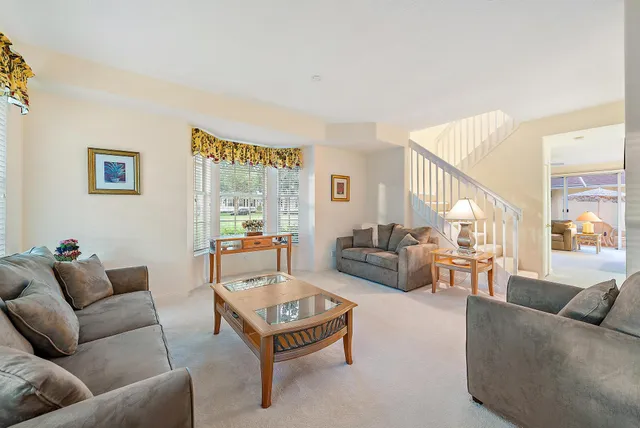 a living room with furniture a table and a flat screen tv