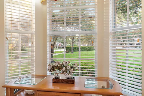 a living room with furniture a sink and a large mirror
