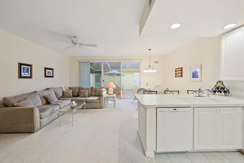 a kitchen with a dining table chairs refrigerator and cabinets