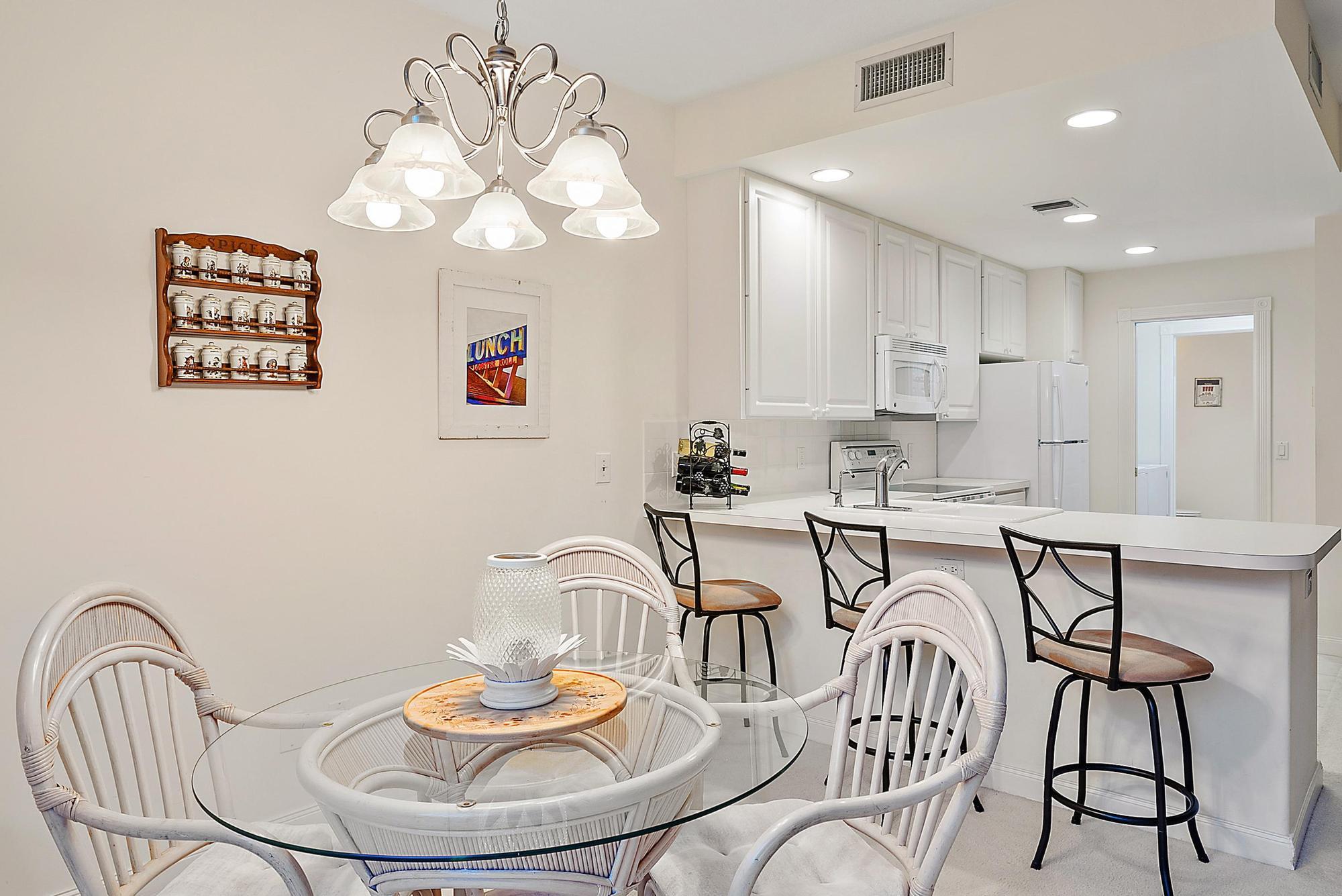 277 New Haven Boulevard Jupiter, FL 33458 - Photo 20 of 36 a dining room with furniture and a chandelier