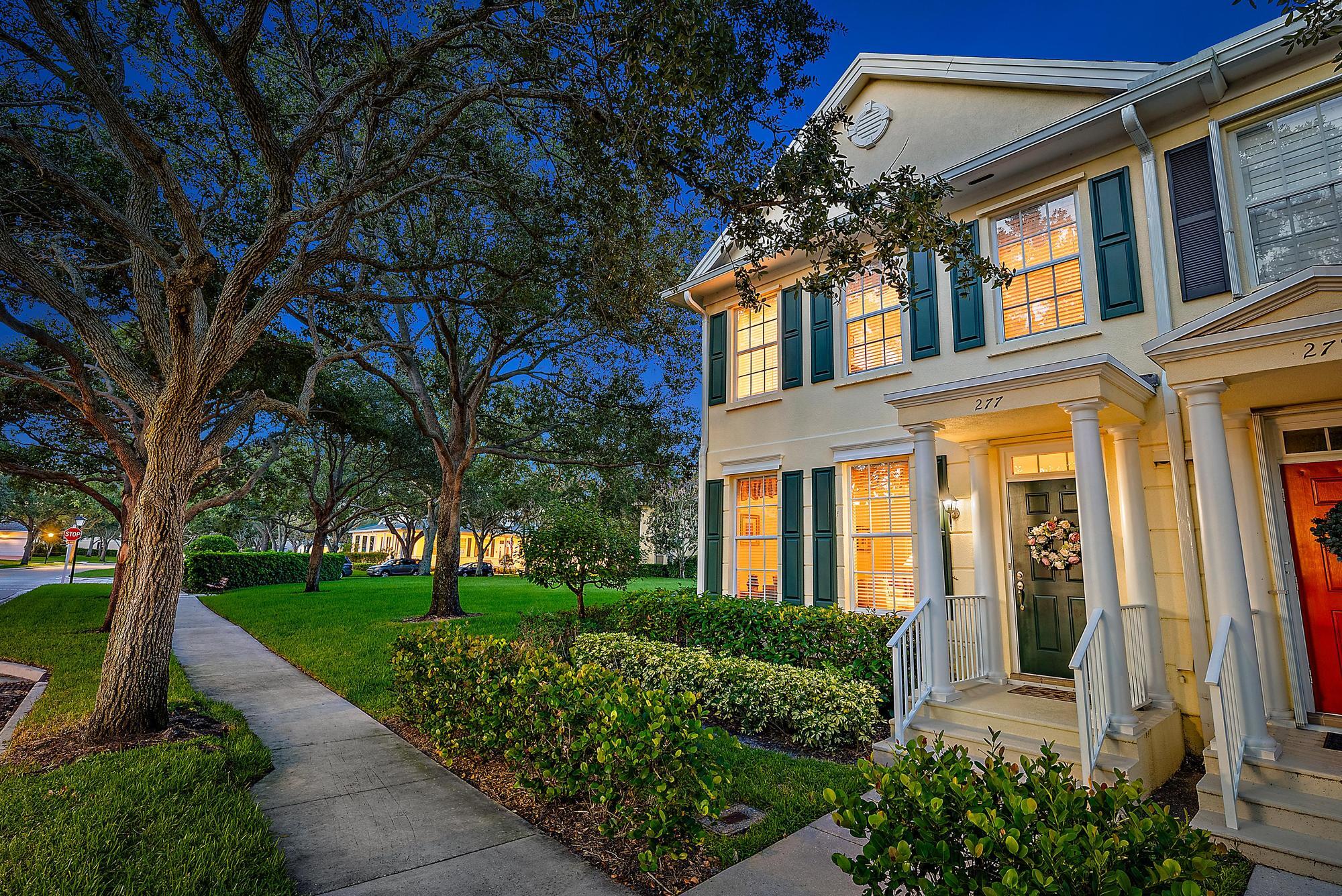 277 New Haven Boulevard Jupiter, FL 33458 - Photo 2 of 36 front view of a brick house with a yard