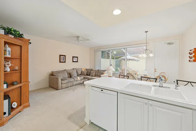 a living room with furniture and kitchen view
