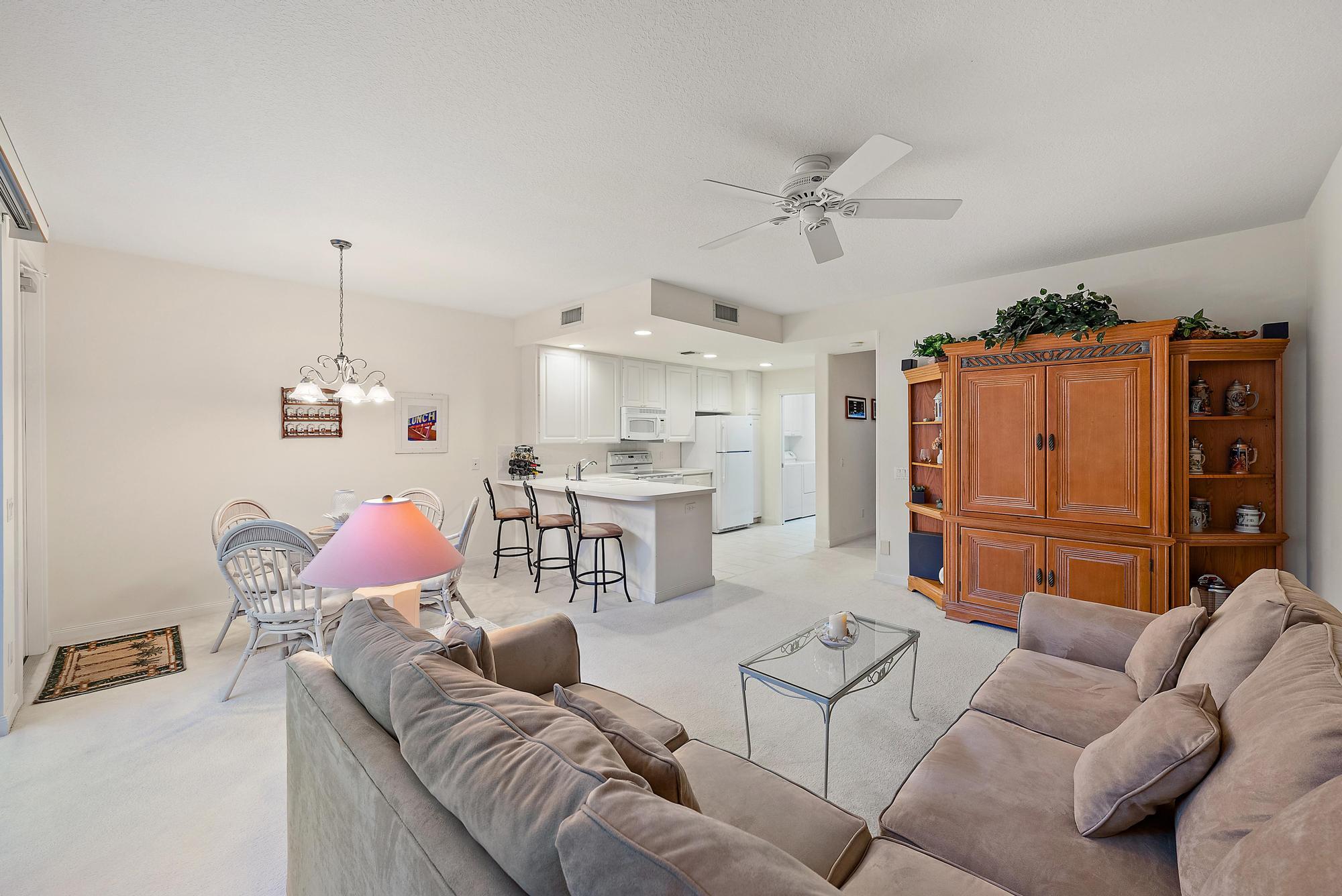 277 New Haven Boulevard Jupiter, FL 33458 - Photo 22 of 36 a living room with furniture and kitchen view