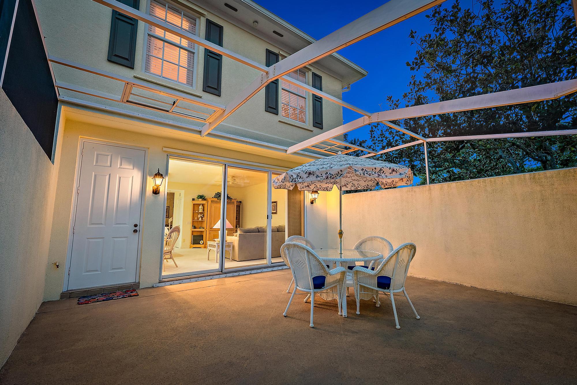 277 New Haven Boulevard Jupiter, FL 33458 - Photo 23 of 36 a view of a patio with table and chairs and wooden floor
