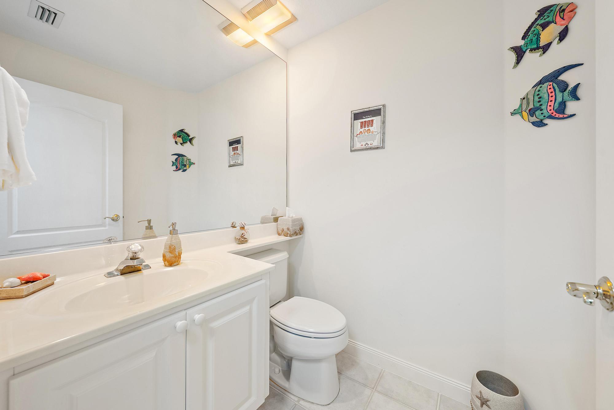 277 New Haven Boulevard Jupiter, FL 33458 - Photo 26 of 36 a bathroom with a sink a toilet and a mirror