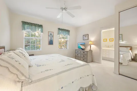 a bathroom with a tub a sink and a window