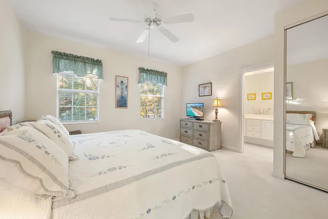 a bathroom with a tub a sink and a window