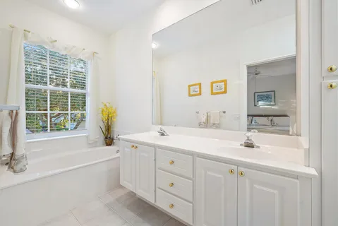 a bathroom with bathtub and a window