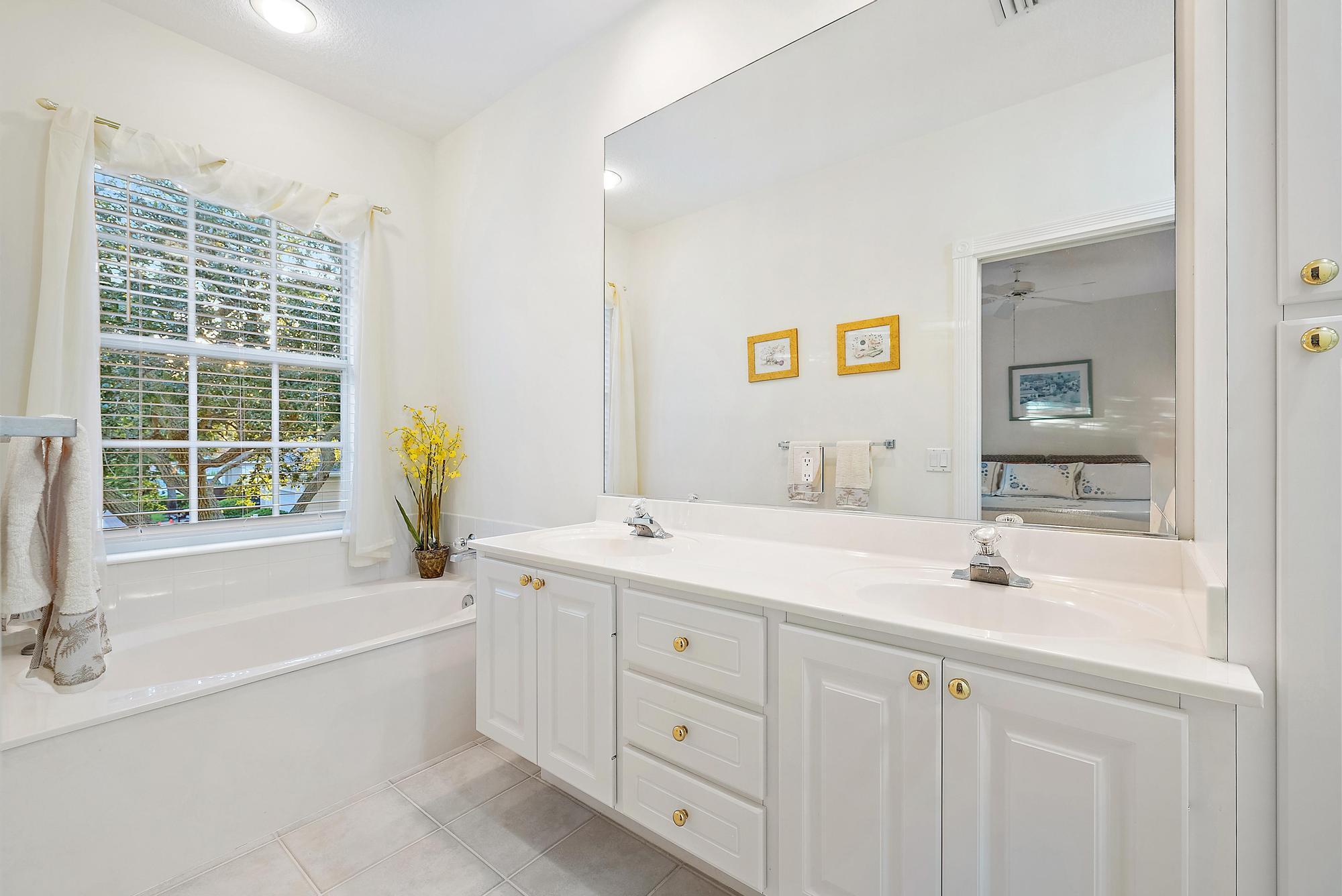 277 New Haven Boulevard Jupiter, FL 33458 - Photo 29 of 36 a bathroom with a tub a sink and a window