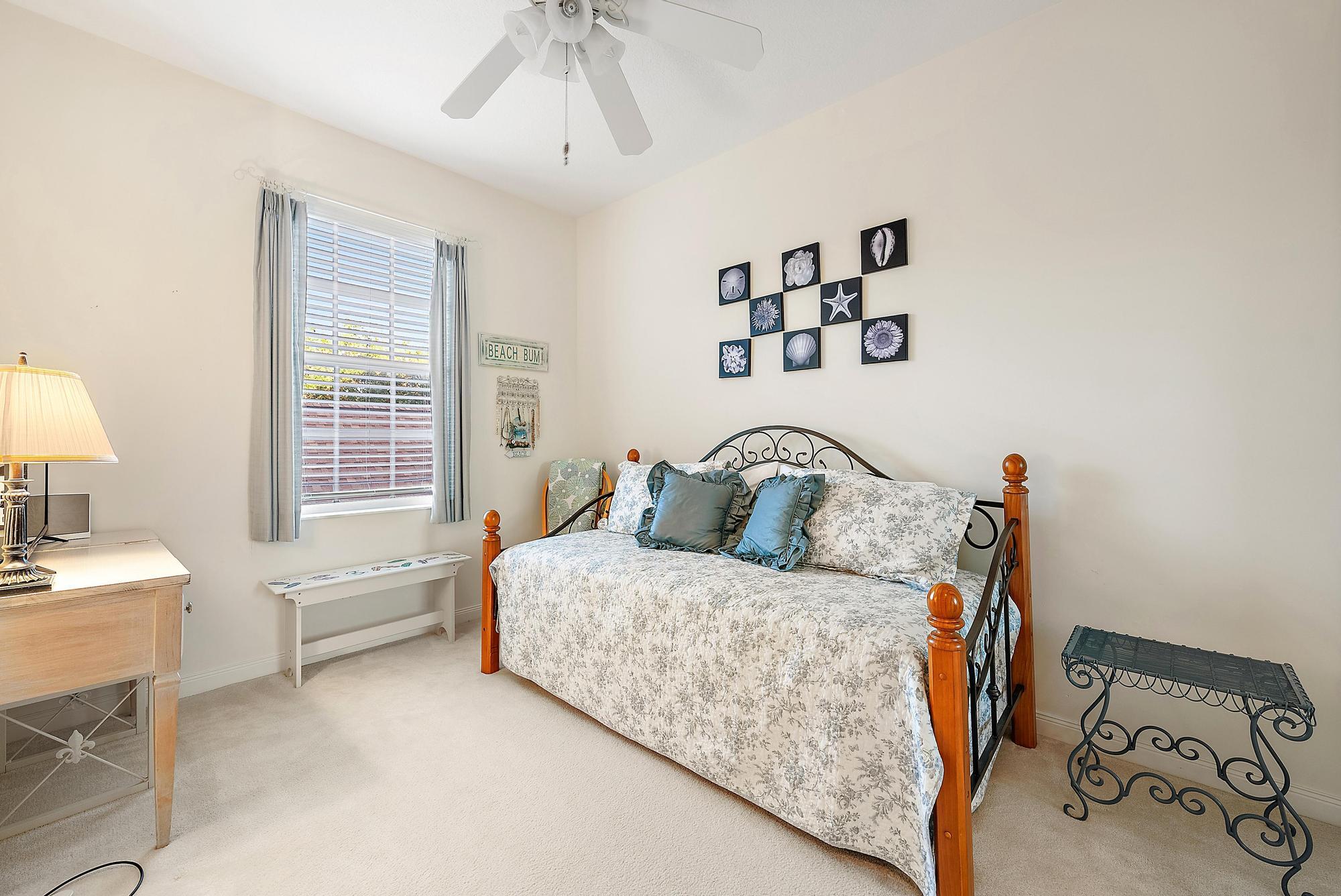 277 New Haven Boulevard Jupiter, FL 33458 - Photo 35 of 36 a bedroom with a bed and a window