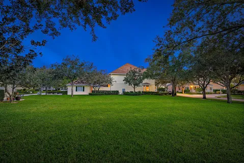 a view of a park with a house in the background