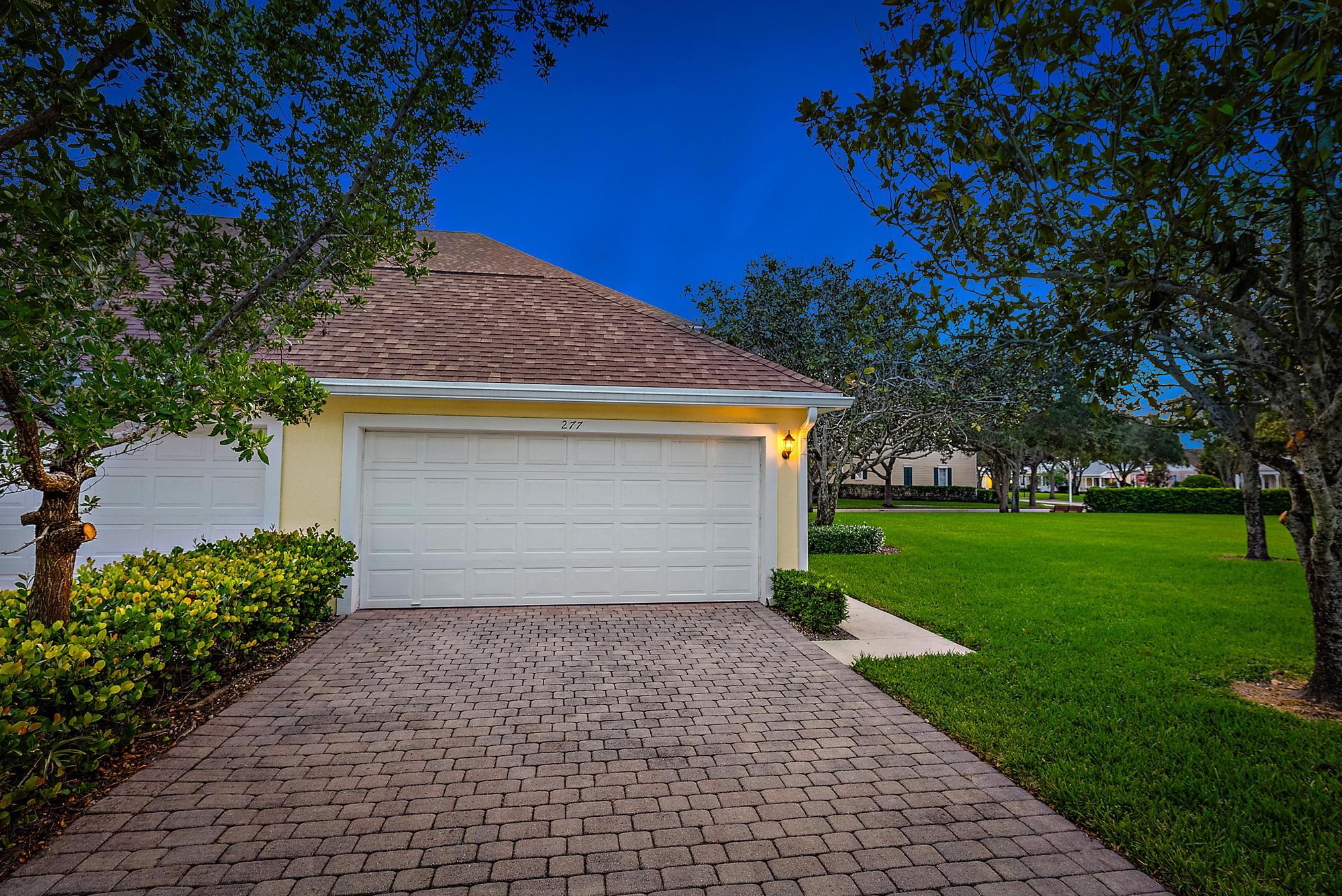 277 New Haven Boulevard Jupiter, FL 33458 - Photo 7 of 36 a front view of a house with a yard and garage