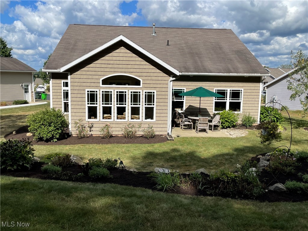 8322 Forest Ridge Street Northwest Massillon, OH 44646 - Photo 5 of 33 Back of property with a patio and a lawn