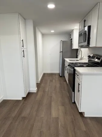 a kitchen with stainless steel appliances granite countertop a stove a sink and a refrigerator