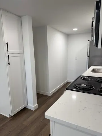 a bedroom with a bed and a wooden floor