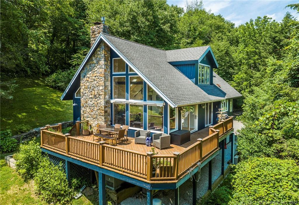 3 Cobble Heights Road Kent, CT 06757 - Photo 1 of 1 a view of a house with wooden deck and furniture