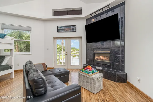 a living room with furniture a flat screen tv and a fireplace