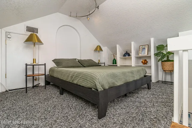 a view of a chairs and table in patio with a lake view
