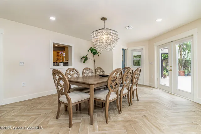 a view of a dining room with furniture and chandelier