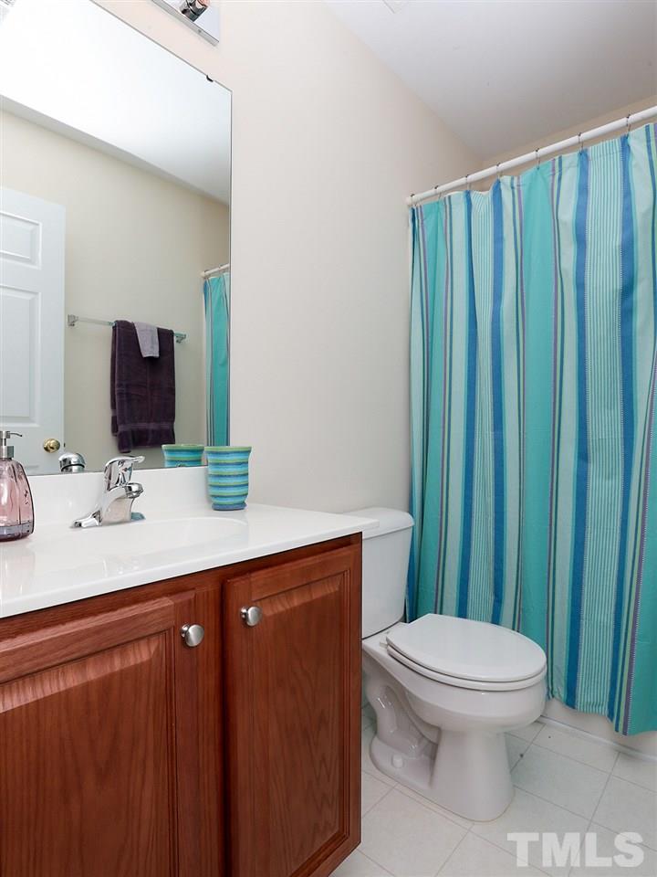 2708 Andover Glen Road Raleigh, NC 27604 - Photo 17 of 25 a bathroom with a sink a toilet and mirror