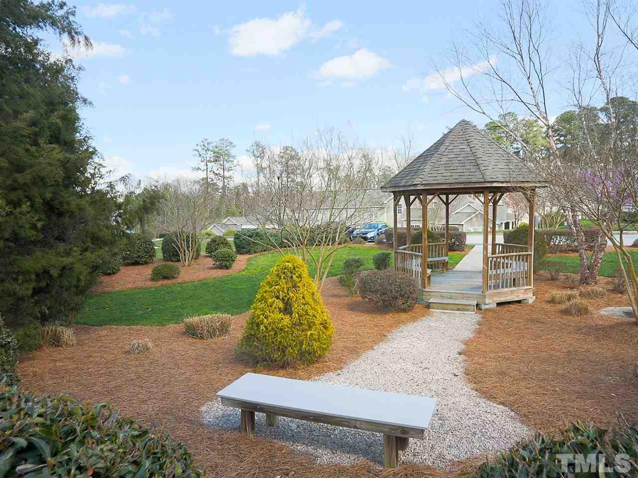2708 Andover Glen Road Raleigh, NC 27604 - Photo 22 of 25 a view of a patio with couches and a table and chairs with wooden fence