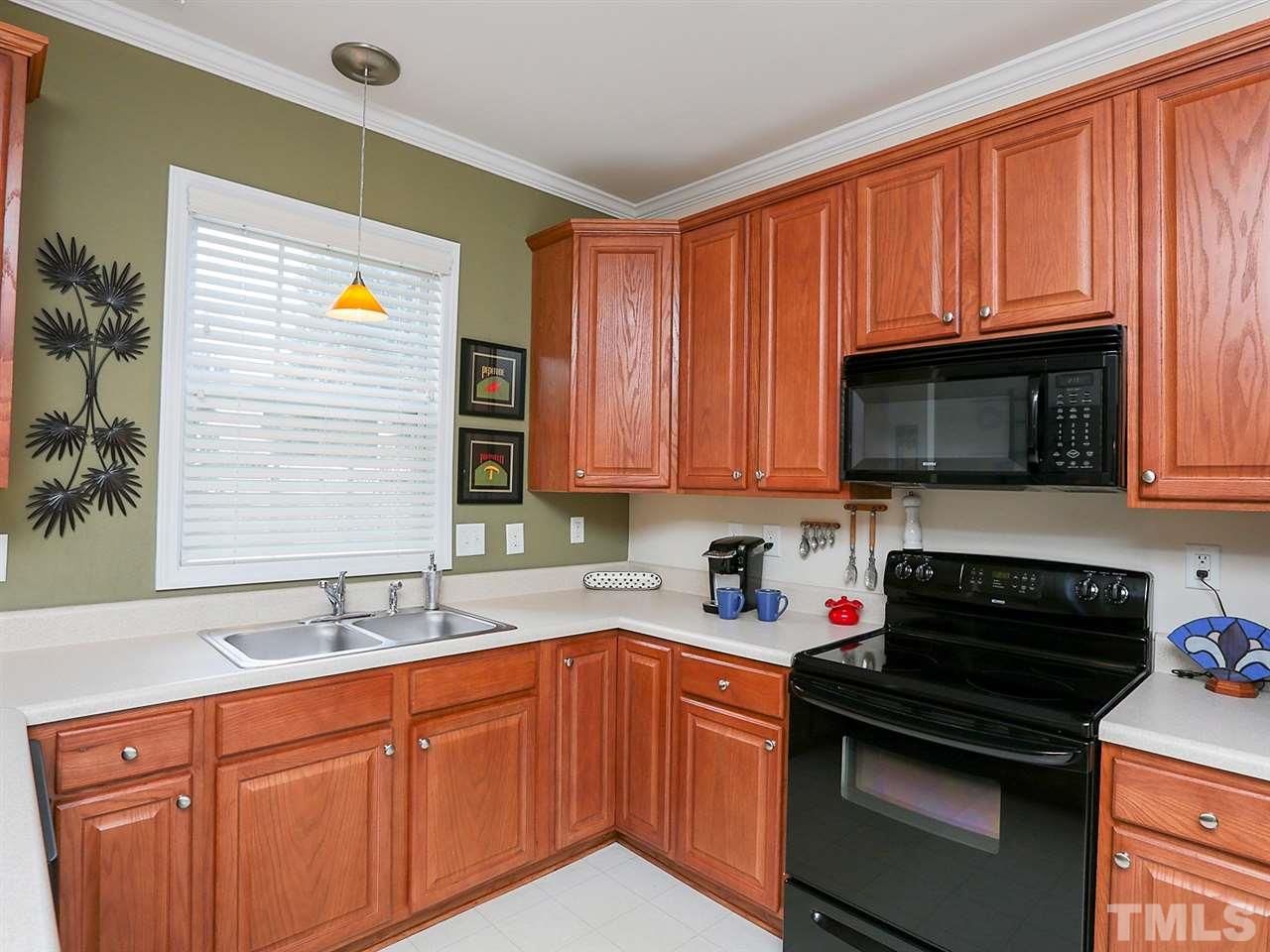2708 Andover Glen Road Raleigh, NC 27604 - Photo 6 of 25 a kitchen with stainless steel appliances granite countertop a sink stove and microwave