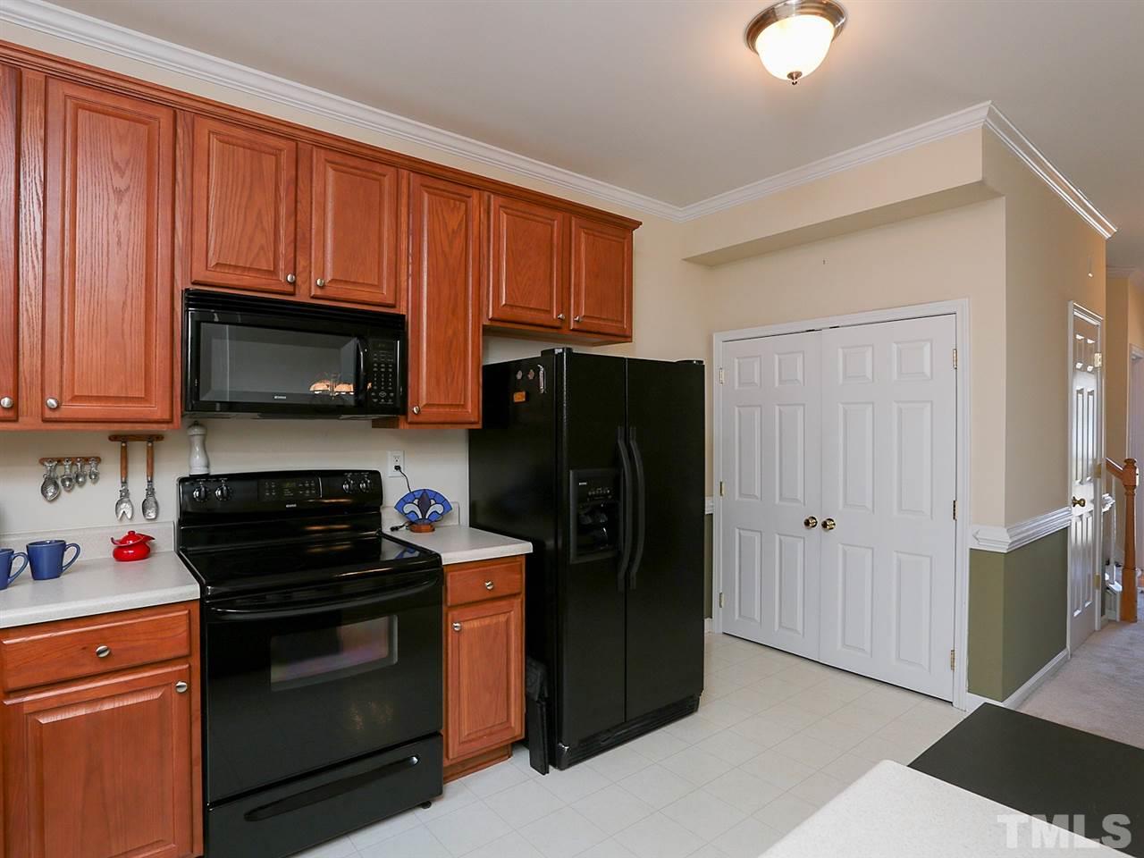 2708 Andover Glen Road Raleigh, NC 27604 - Photo 7 of 25 a kitchen with a refrigerator stove and microwave